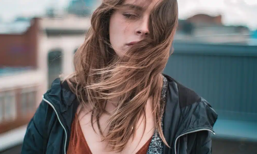 woman wearing blue zip-up jacket