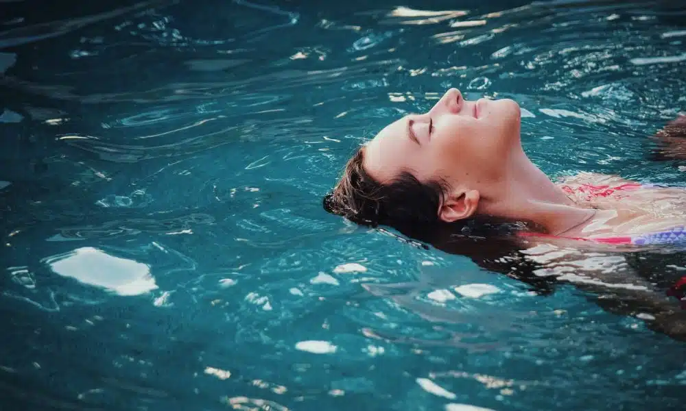 woman floating on body of water