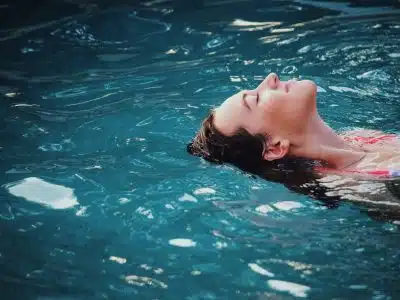 woman floating on body of water